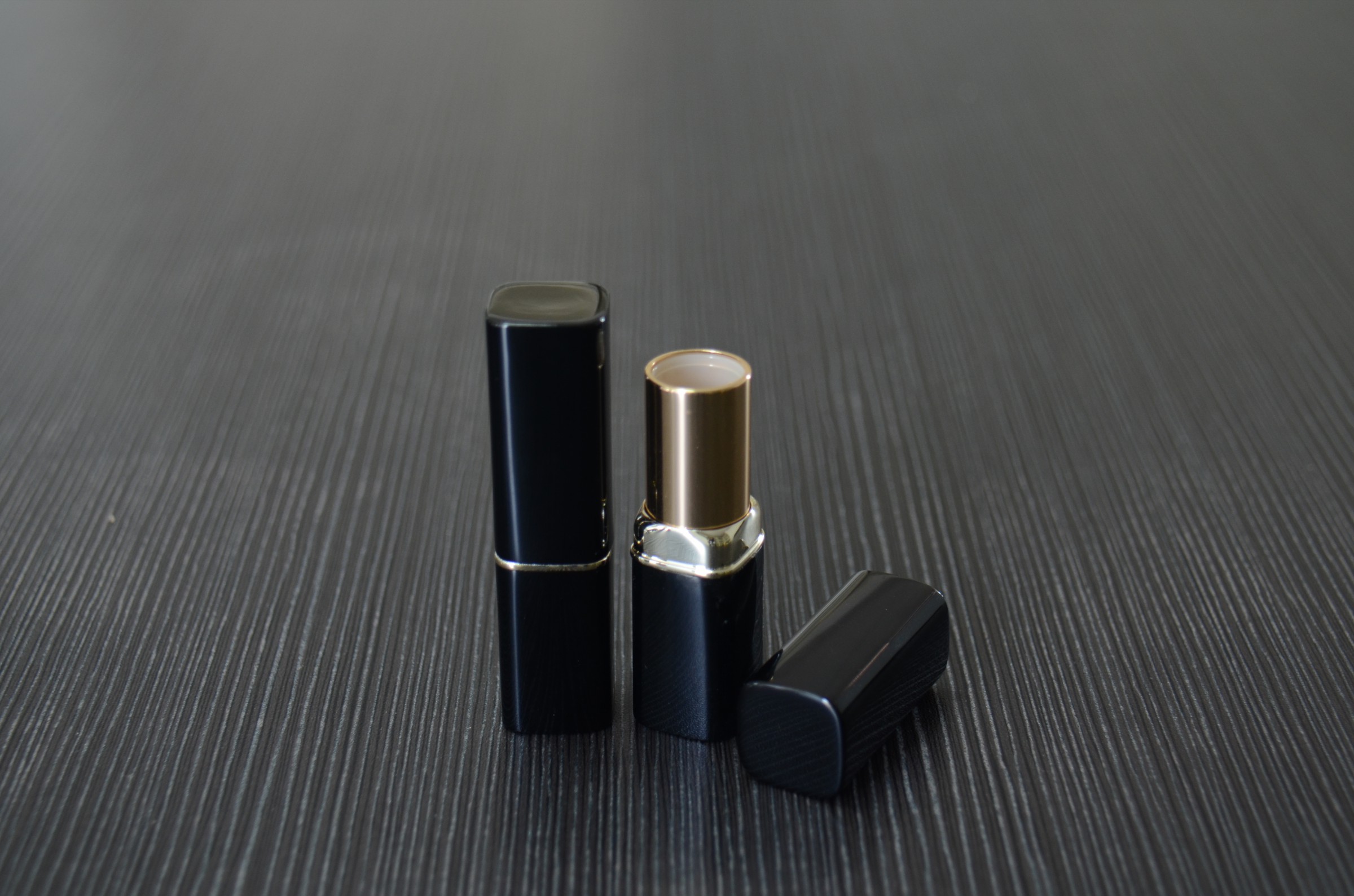 black empty metal lipstick tube